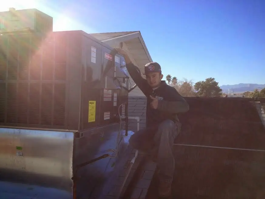 HVAC technician performing AC Tune-Up on a rooftop unit in Manhattan Beach